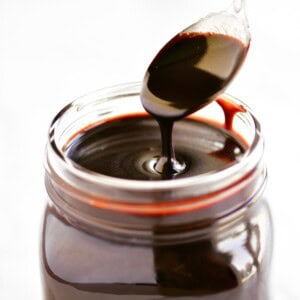 Chocolate sauce being drizzled into a jar.