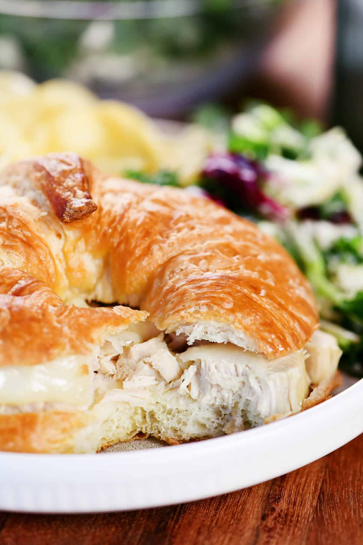 Turkey and cheese croissant on a plate.