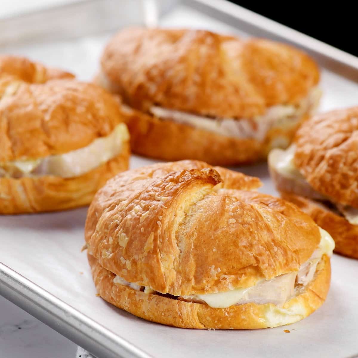 Baked on a baking sheet with parchment paper.