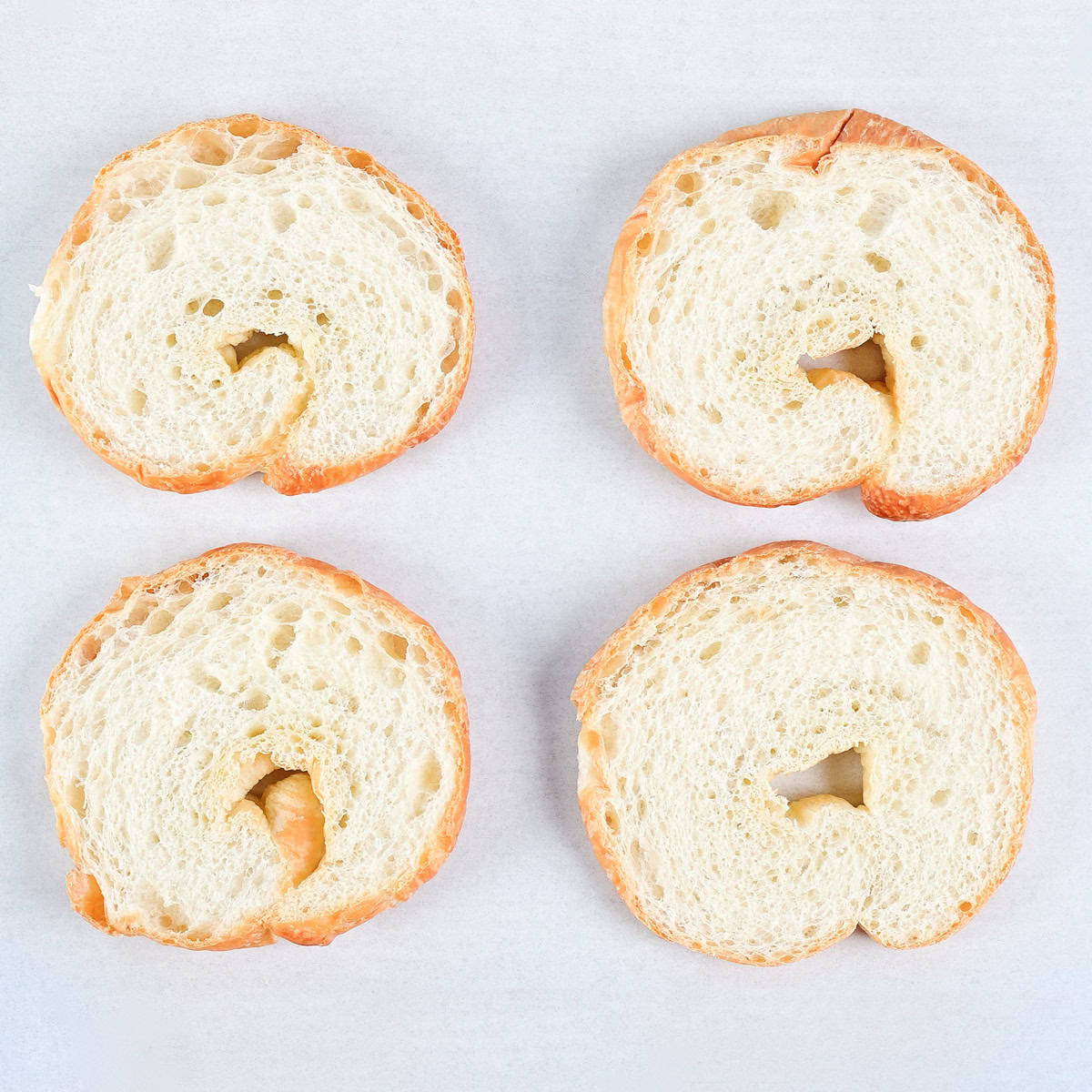 Slice croissants on parchment paper.