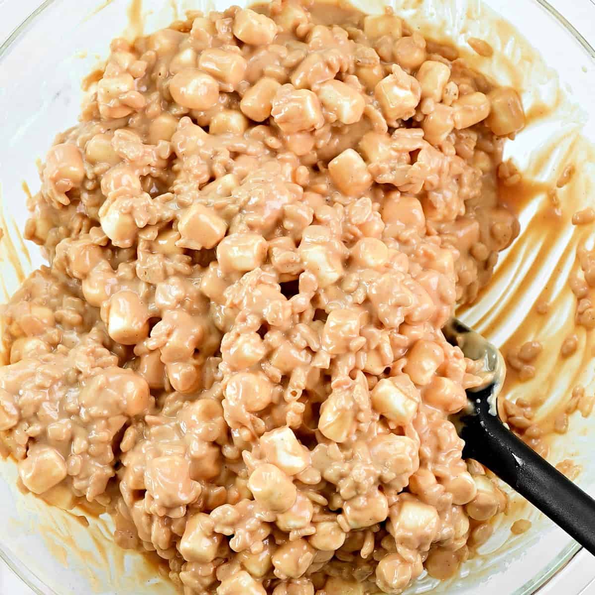 Stirring in mini marshmallows and Rice Krispies.
