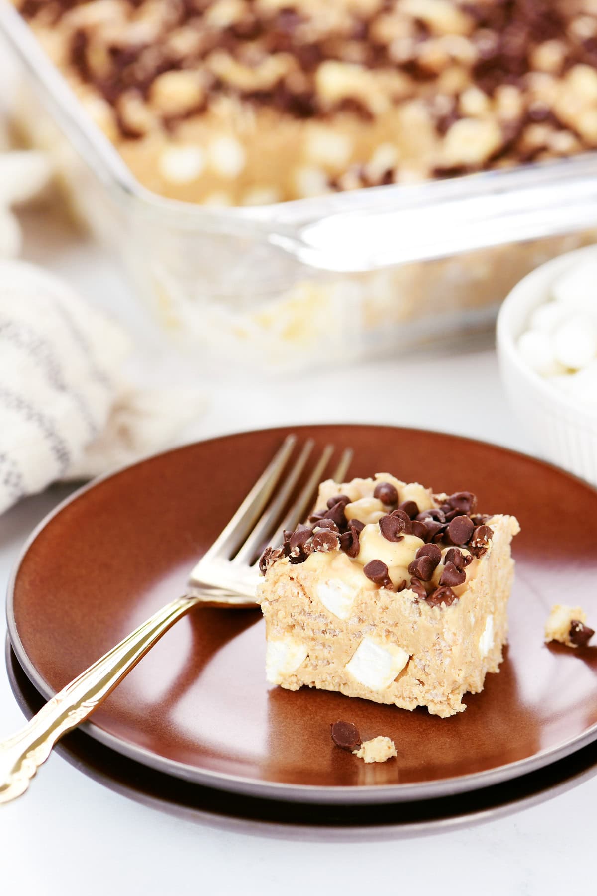 A piece of an avalanche bars on a brown plate with a fork.
