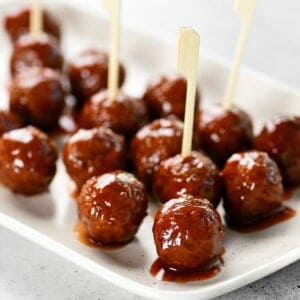 Slow cooker grape jelly meatballs on a platter.