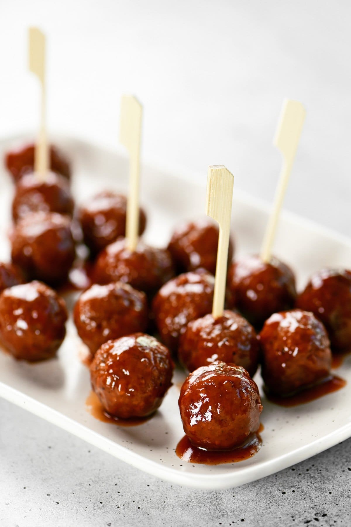 Slow cooker grape jelly meatballs on a platter.