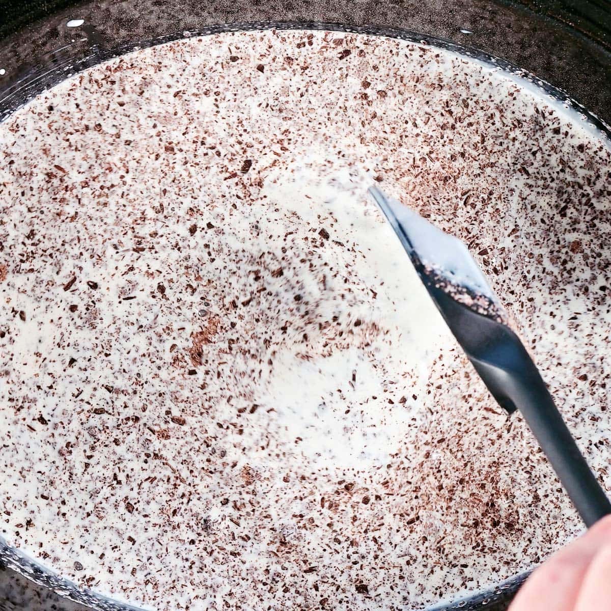 Stirring with a silicone spoon.