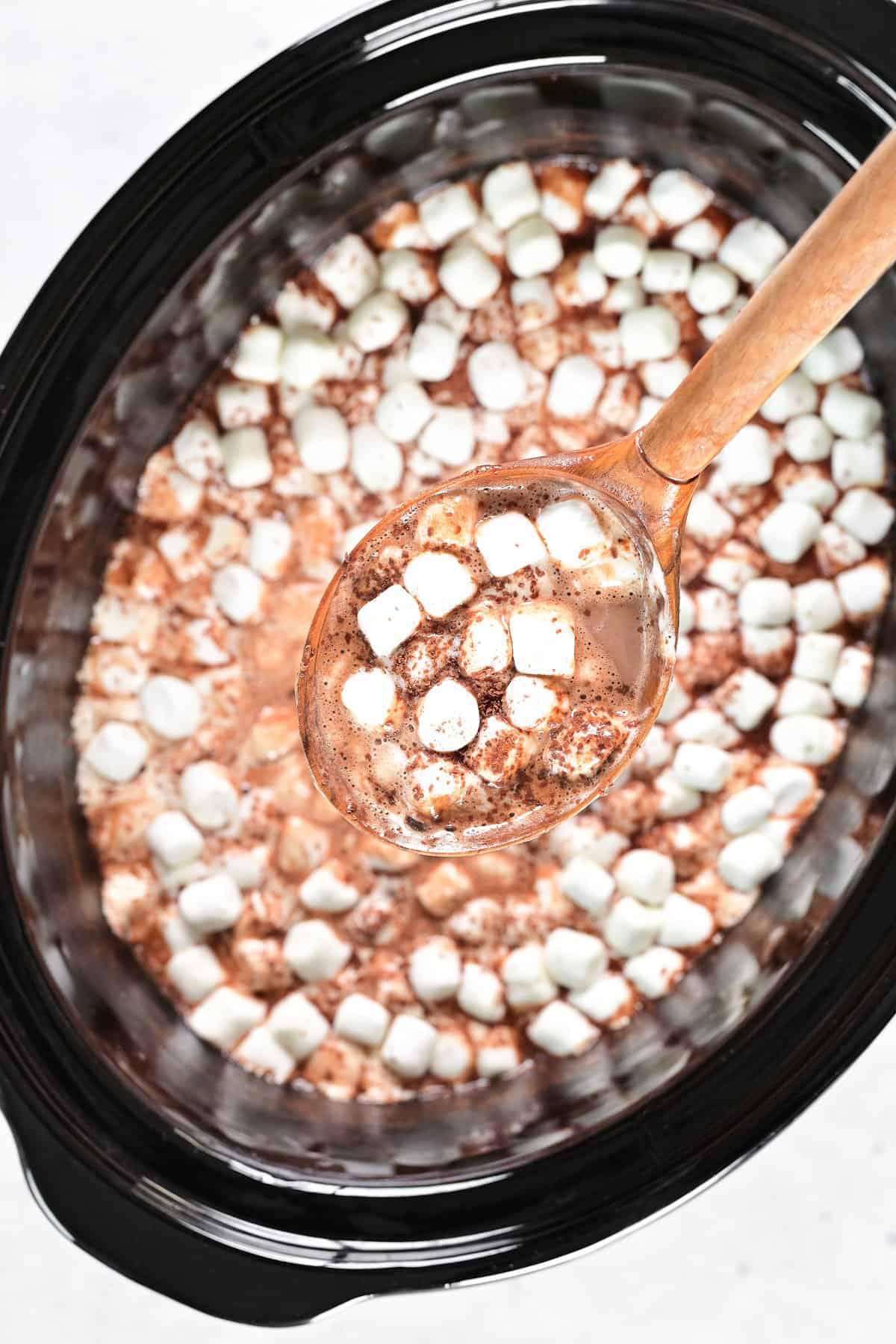 A ladle of slow cooker hot chocolate.