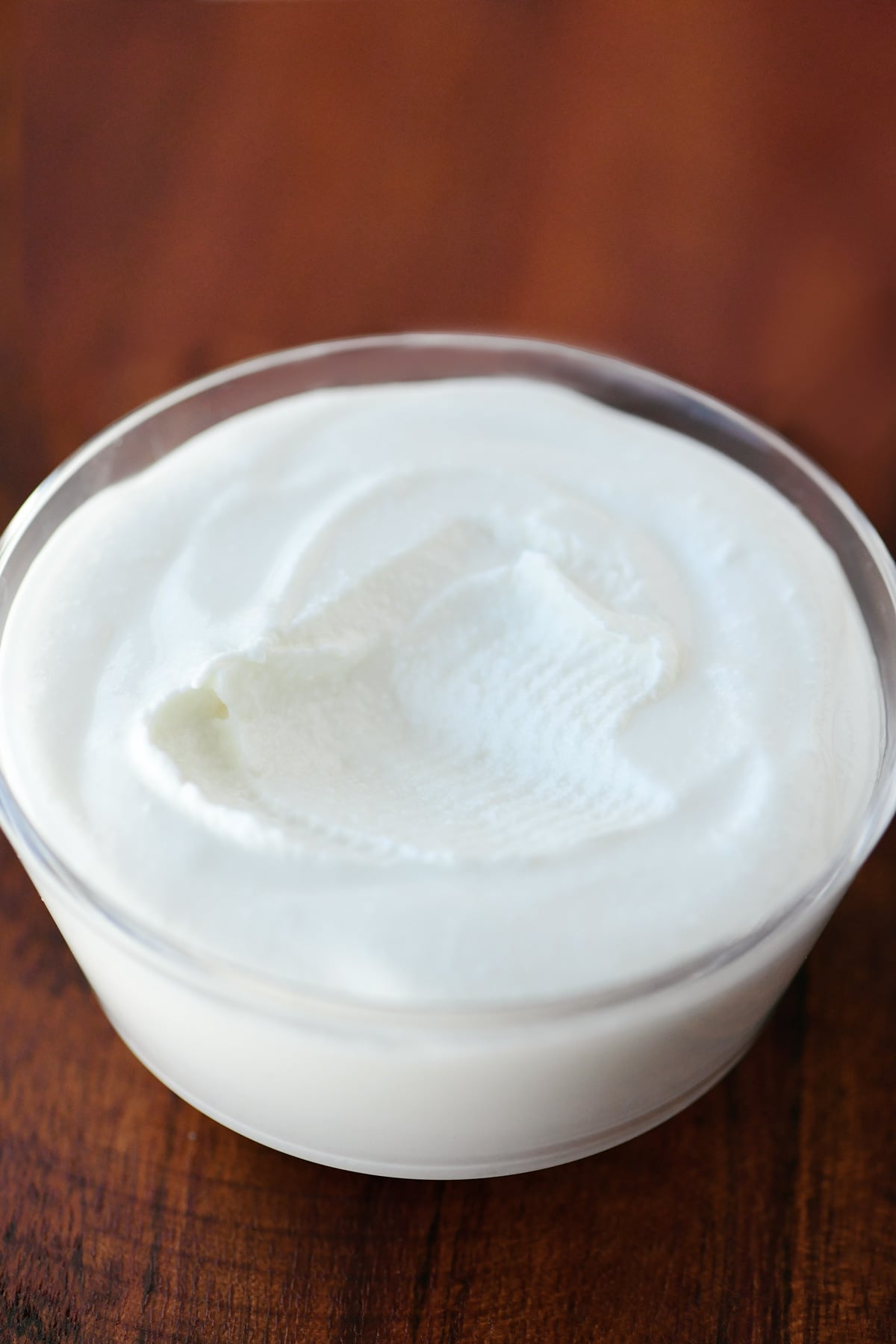 A scoop of blended cottage cheese removed from a bowl.