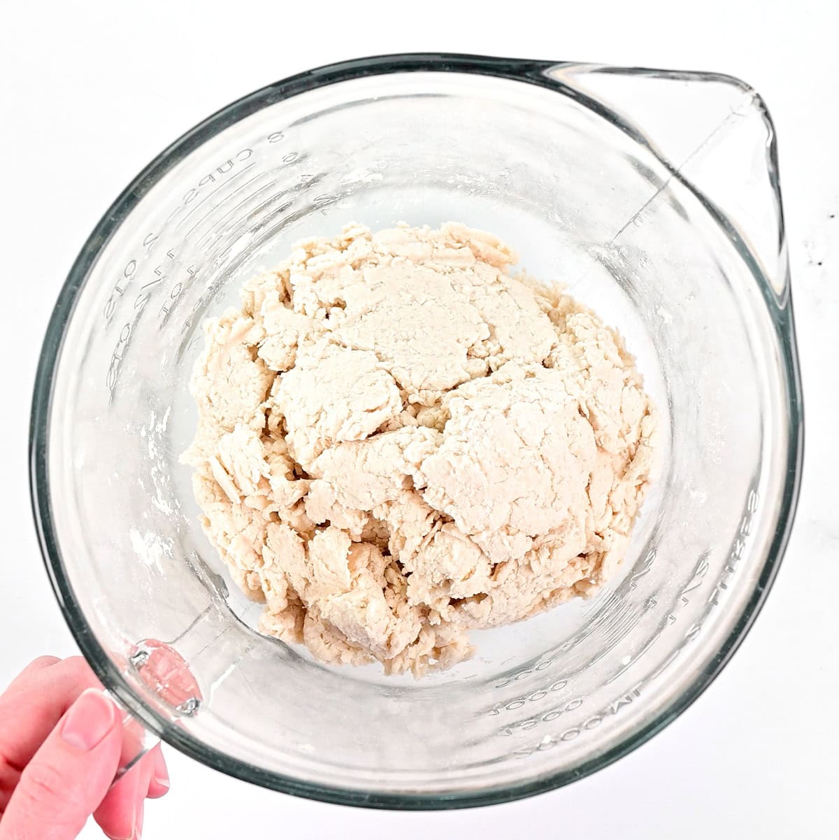 Dough in a glass bowl.
