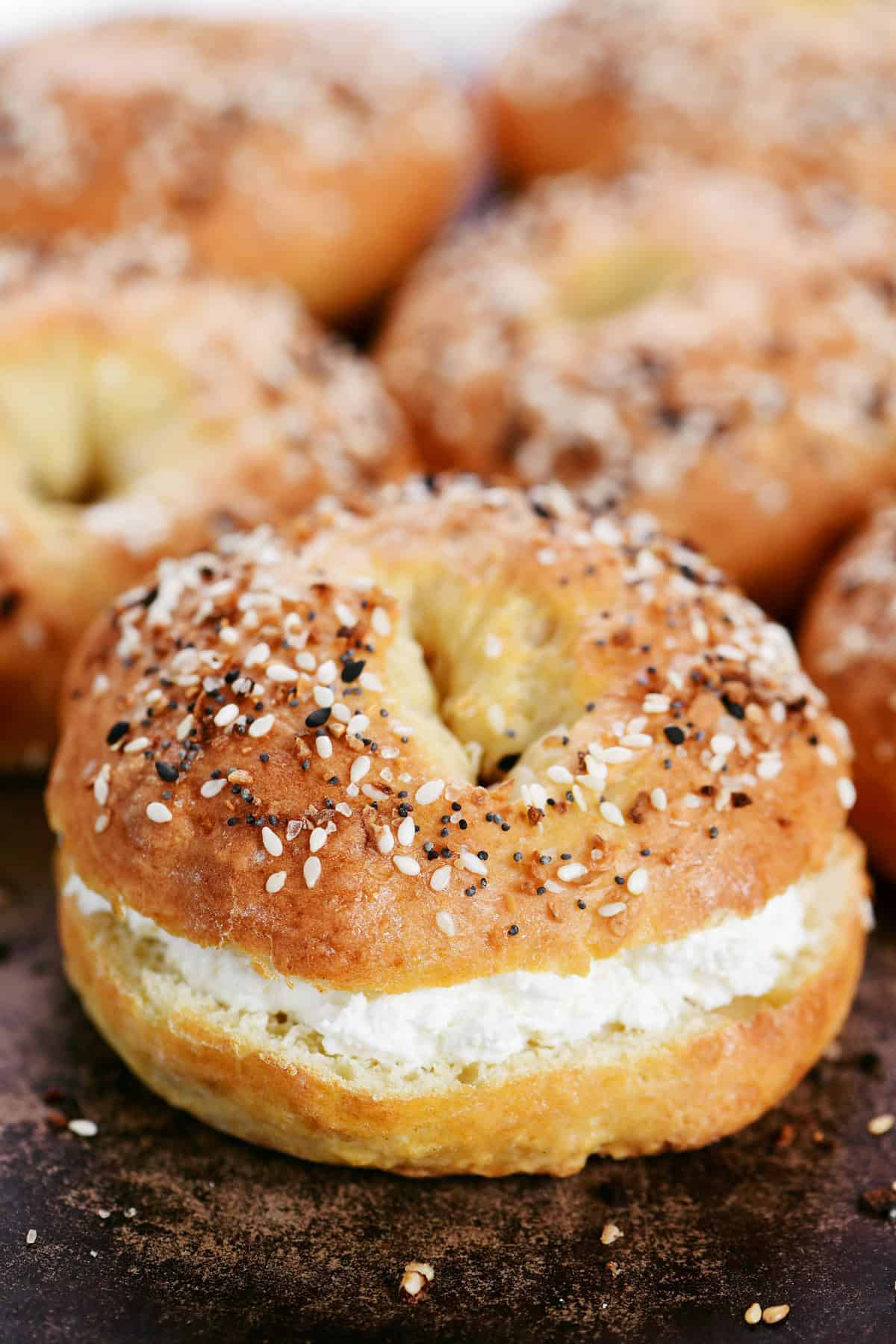 Cottage cheese bagels; one with cream cheese on it.