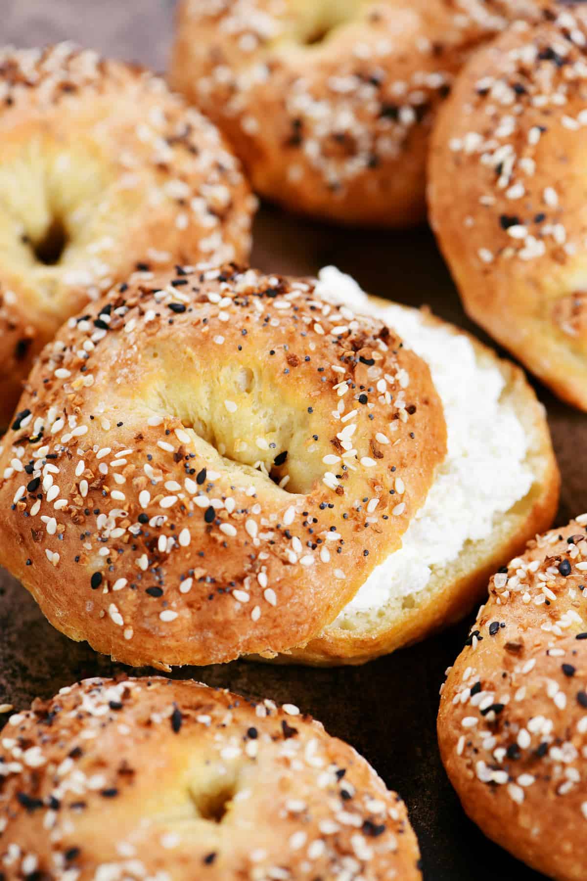 Cottage cheese bagels; one with cream cheese on it.