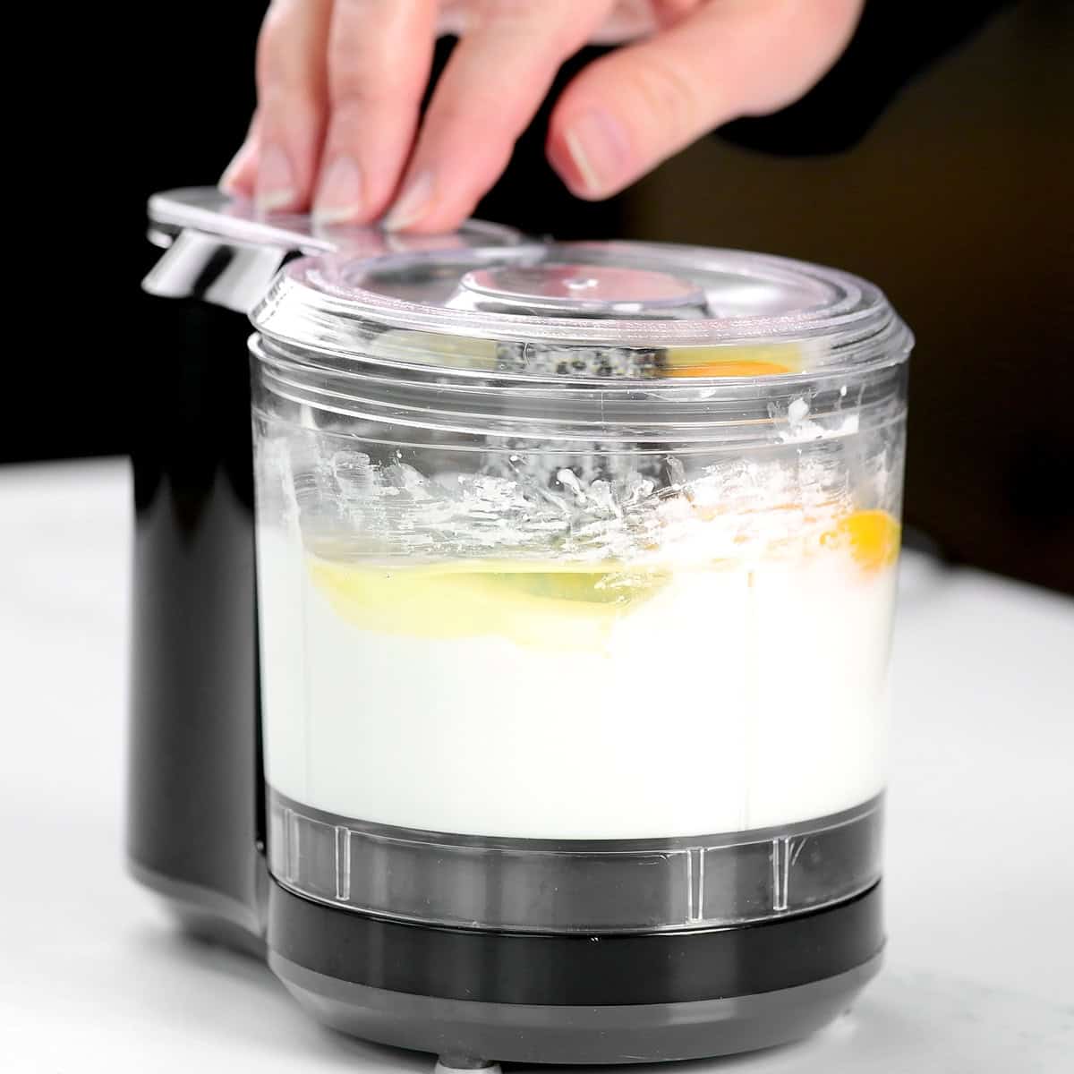 Blended cottage cheese and an egg in a mini food processor.