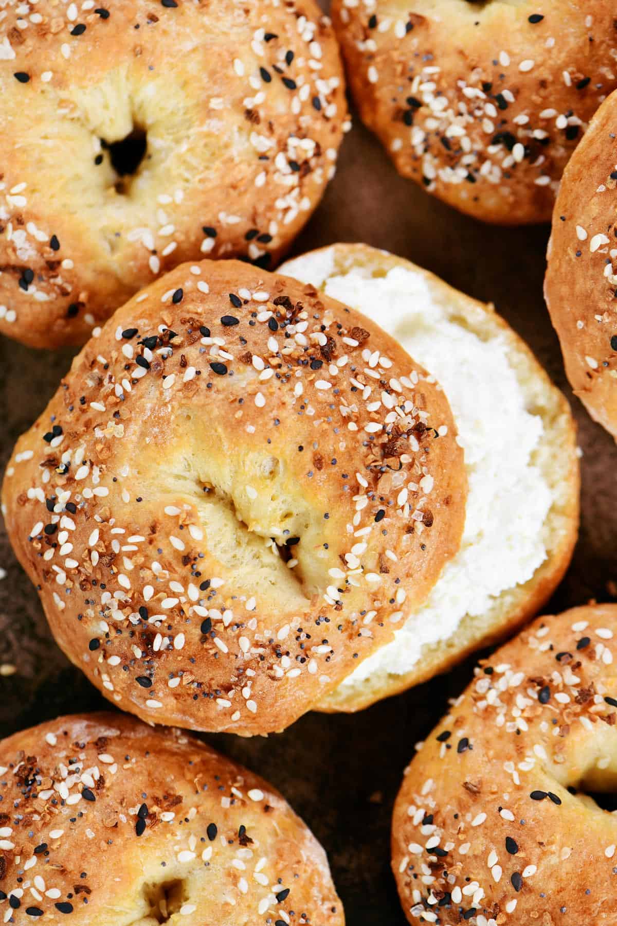 Cottage cheese bagels; one with cream cheese on it.