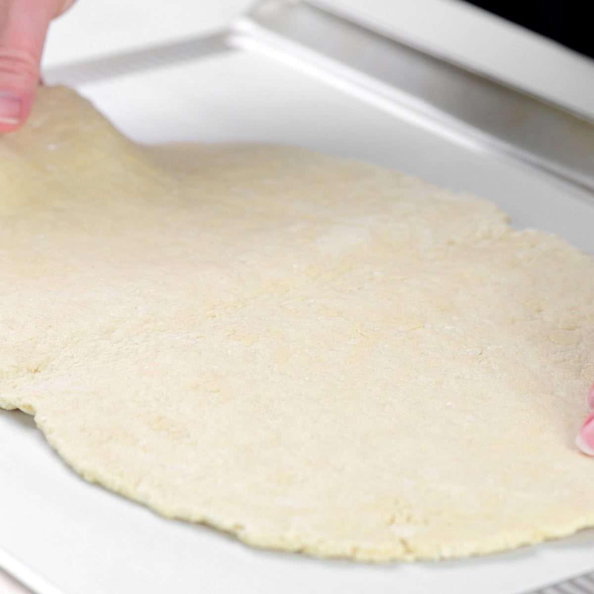 Placing dough on a parchment lined baking sheet.