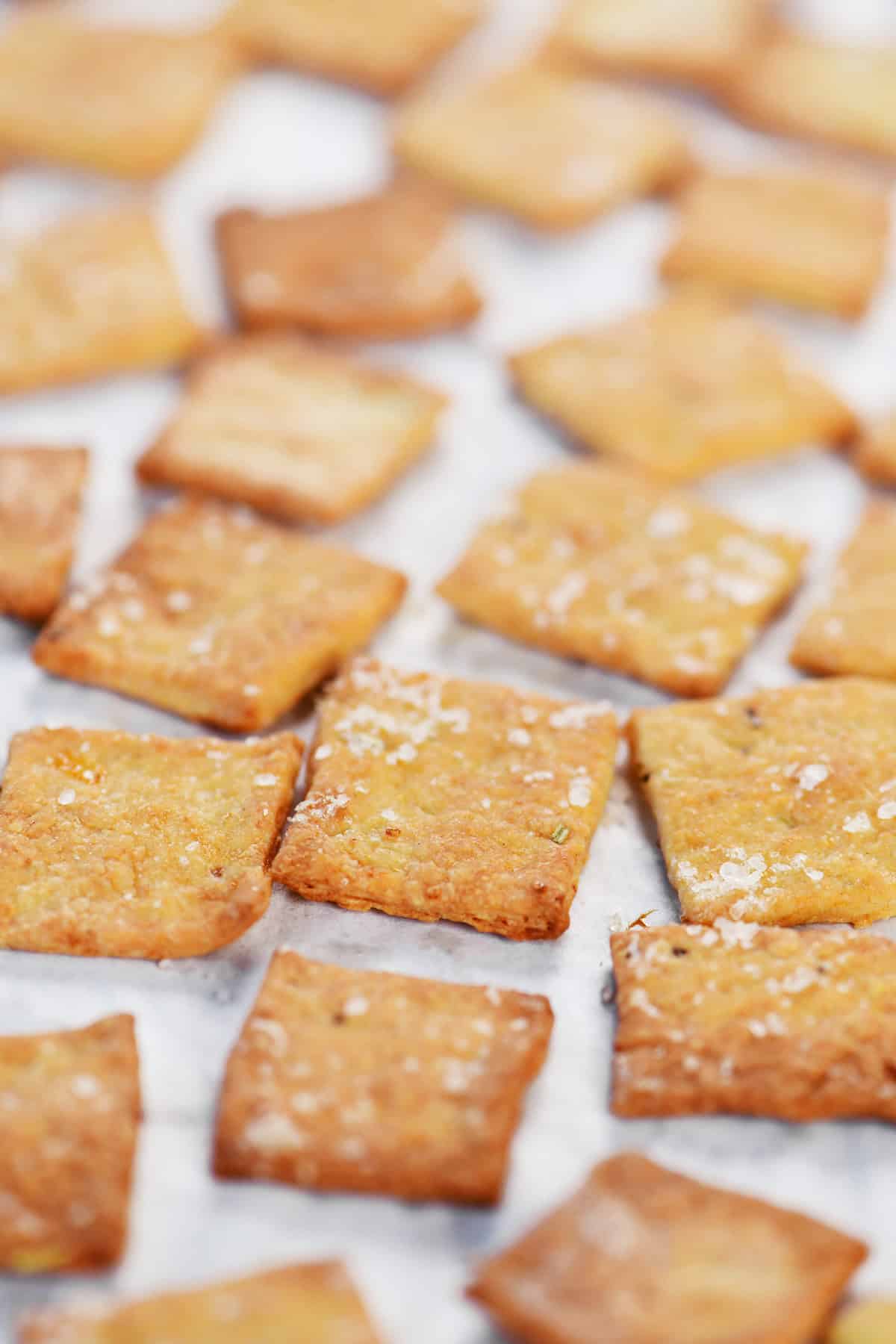 Crispy cottage cheese crackers on a piece of parchment paper.