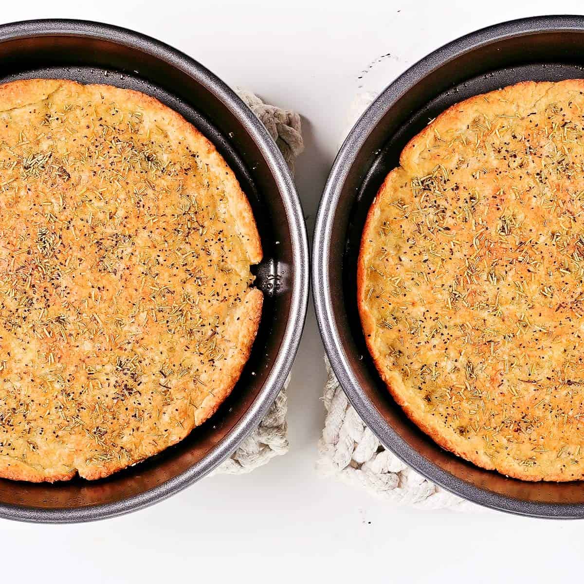 Two pans of baked cottage cheese focaccia.