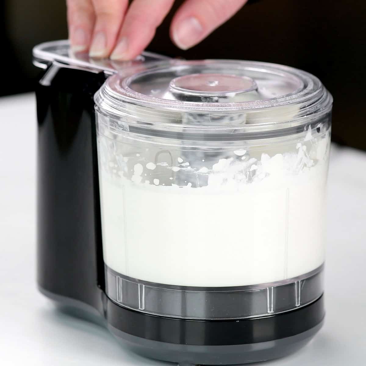 Mini food processor blending cottage cheese.