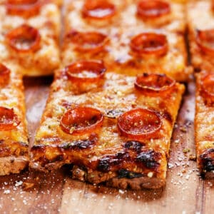 A slice of cottage cheese pizza topped with pepperoni.