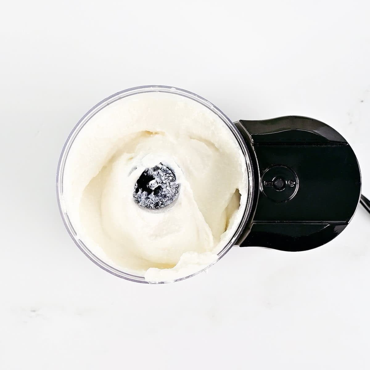 Blended cottage cheese in a mini food processor.