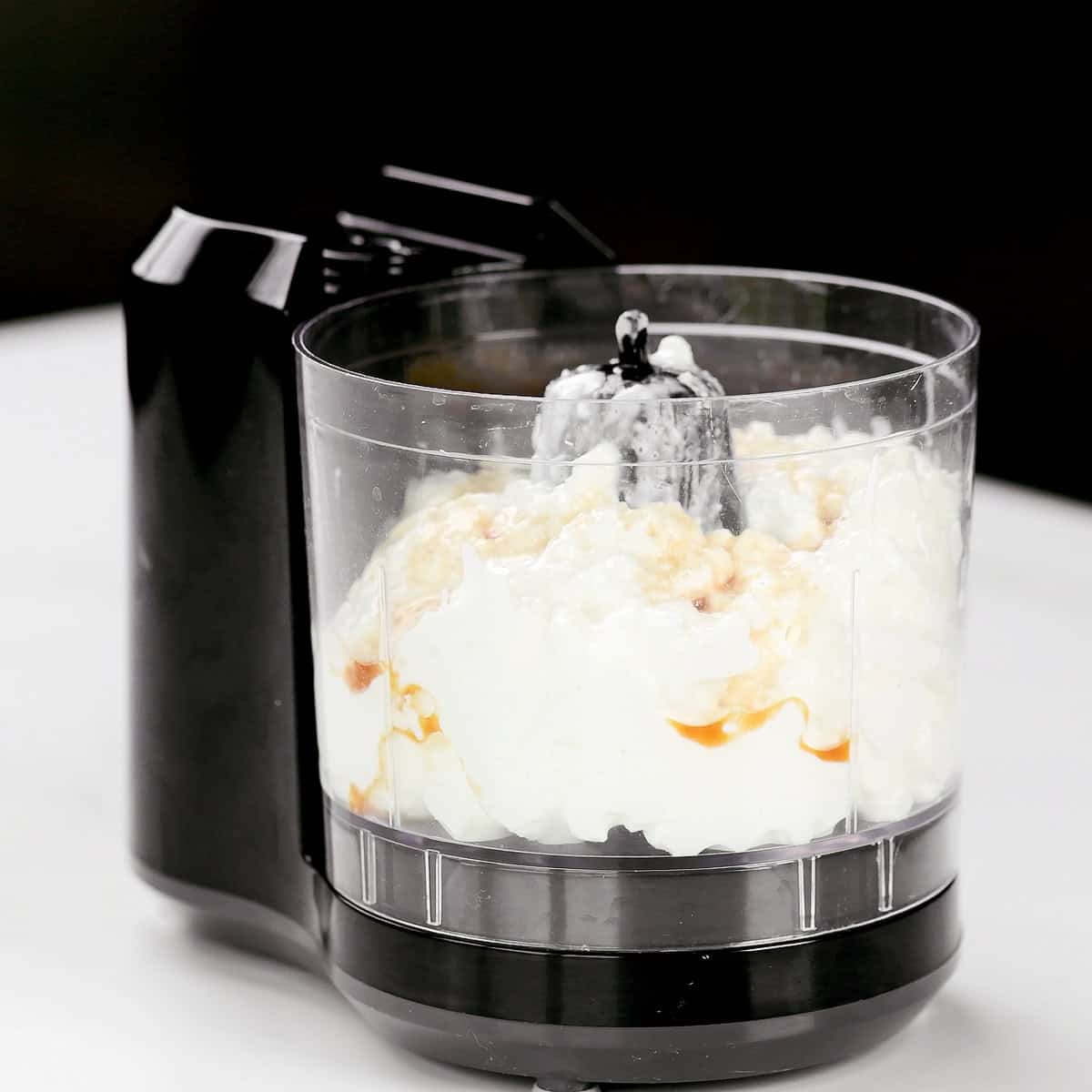 Cottage cheese and vanilla extract in a mini food processor.