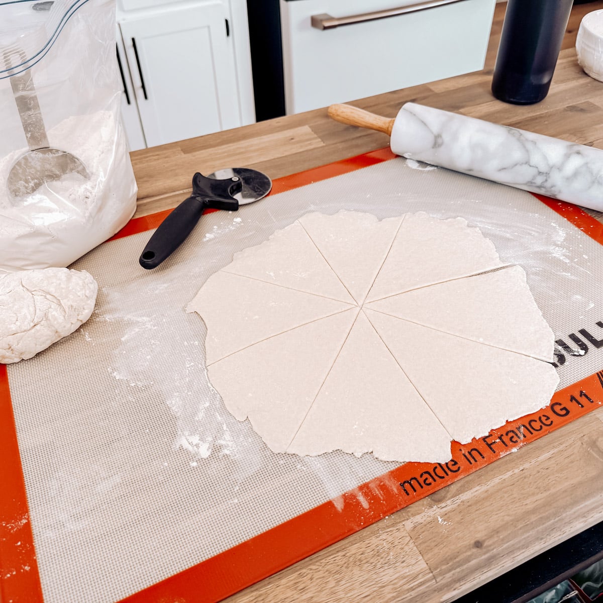 Dough rolled out on a silicone mat.
