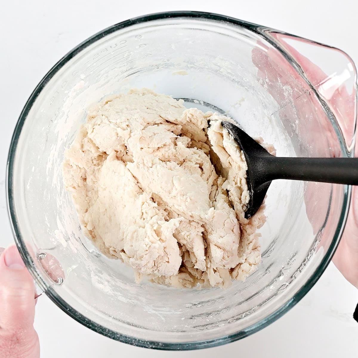 Cottage cheese flatbread dough in a glass bowl.