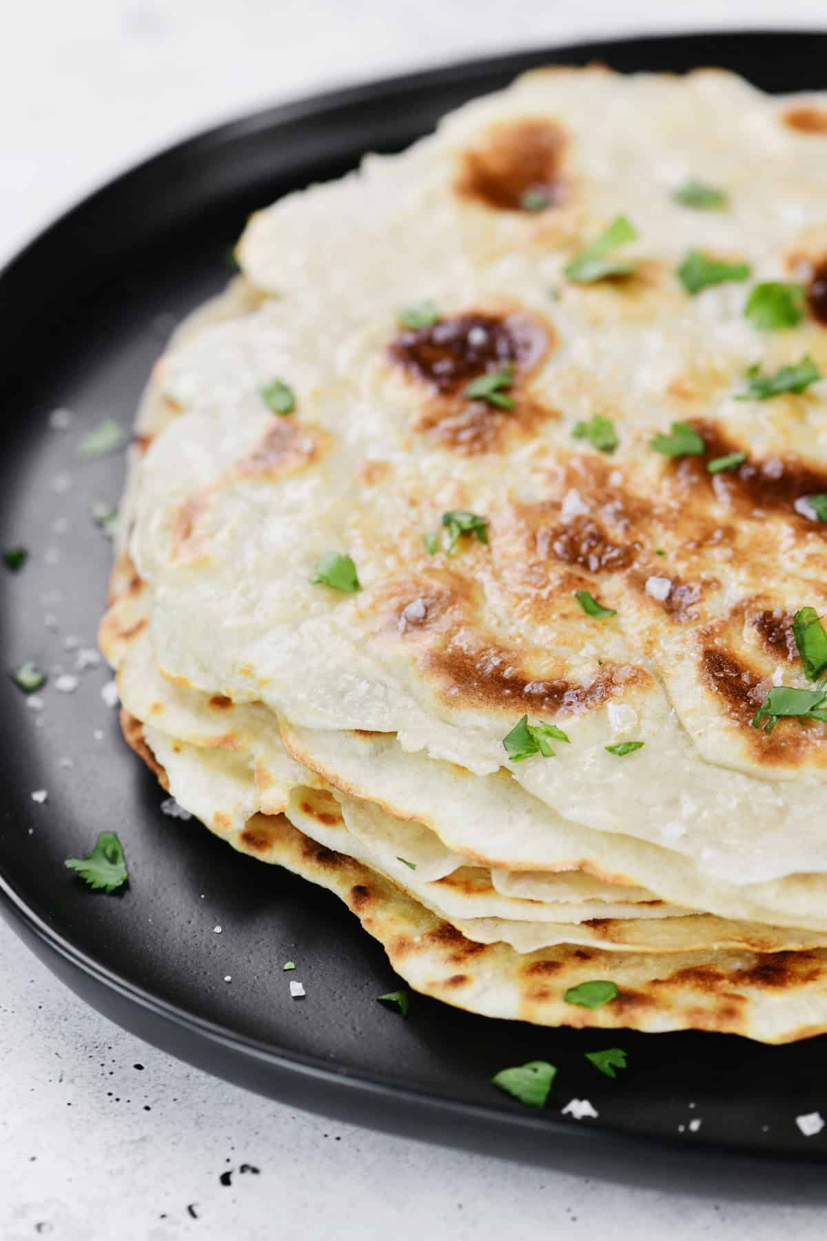 A stack of cottage cheese naan flatbread.