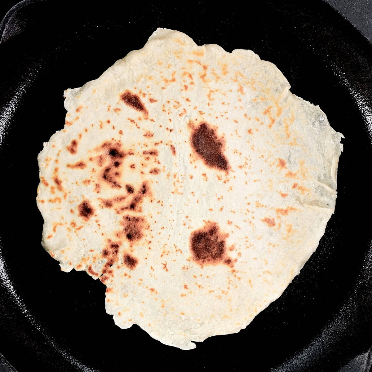 Cottage cheese flatbread in a cast iron skillet.