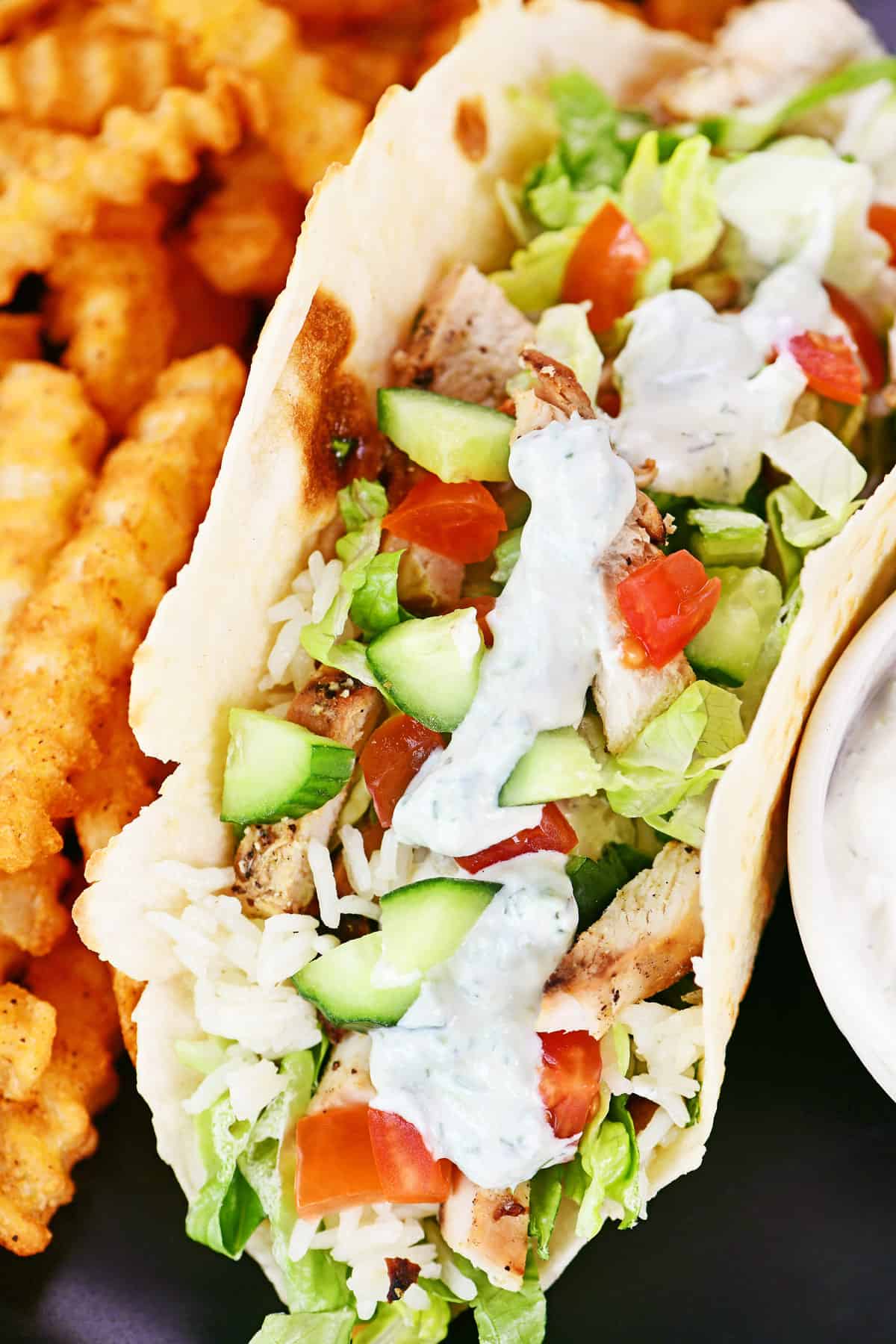 Greek chicken wrap with seasoned fries.