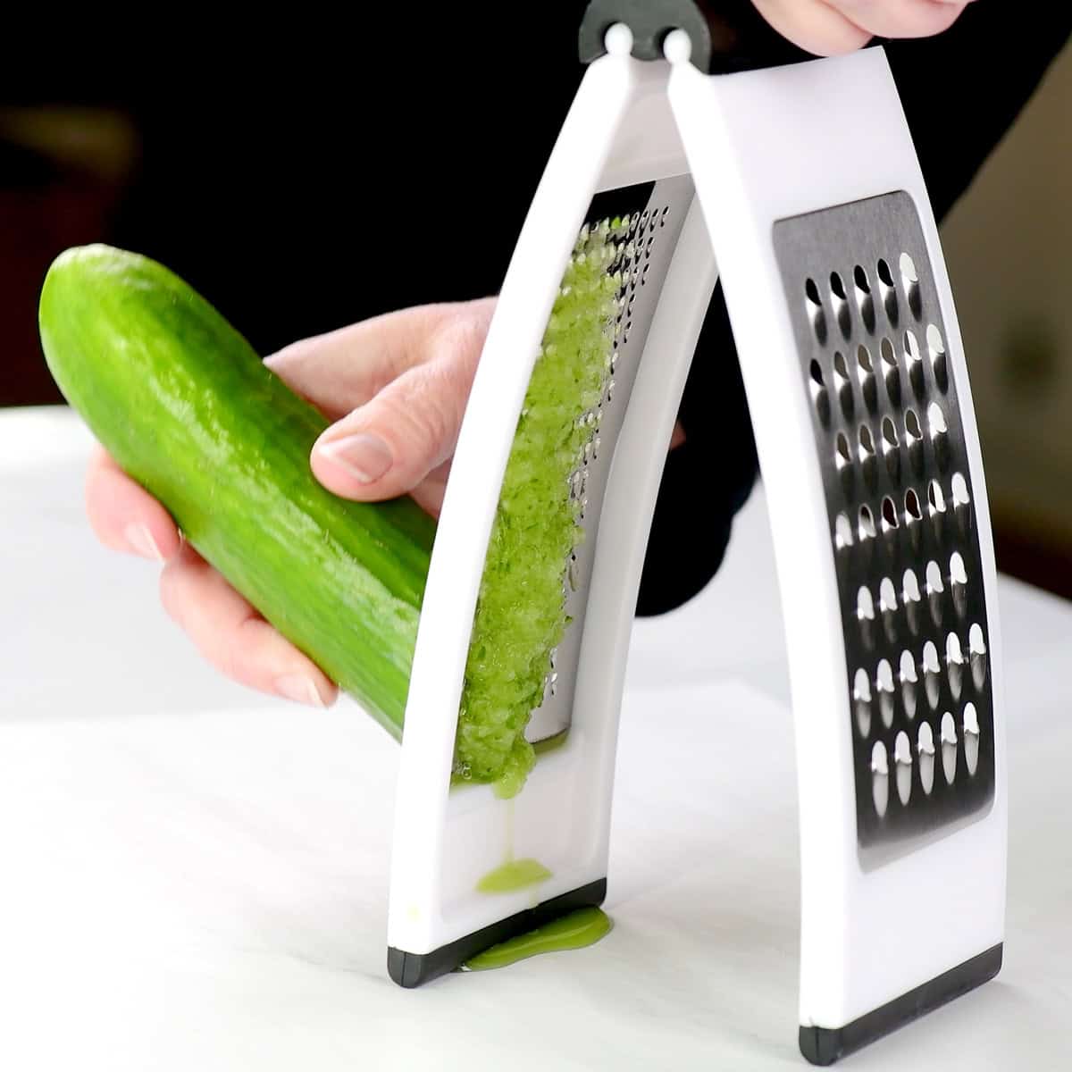 Grating an English seedless cucumber.