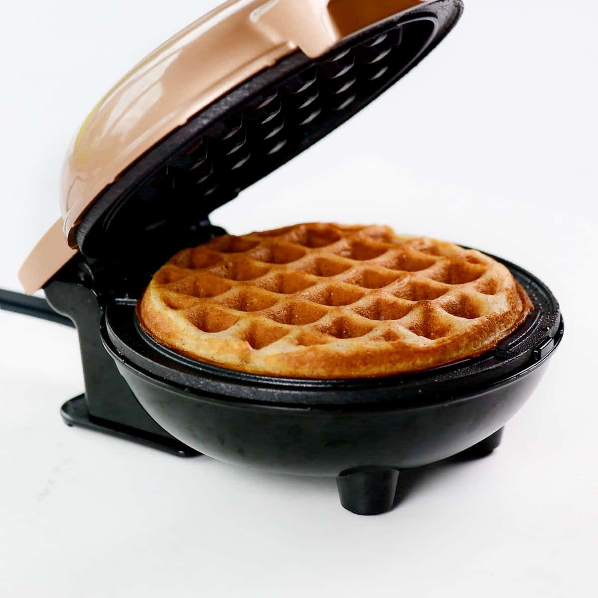 Cooked cottage cheese waffle in a waffle iron.