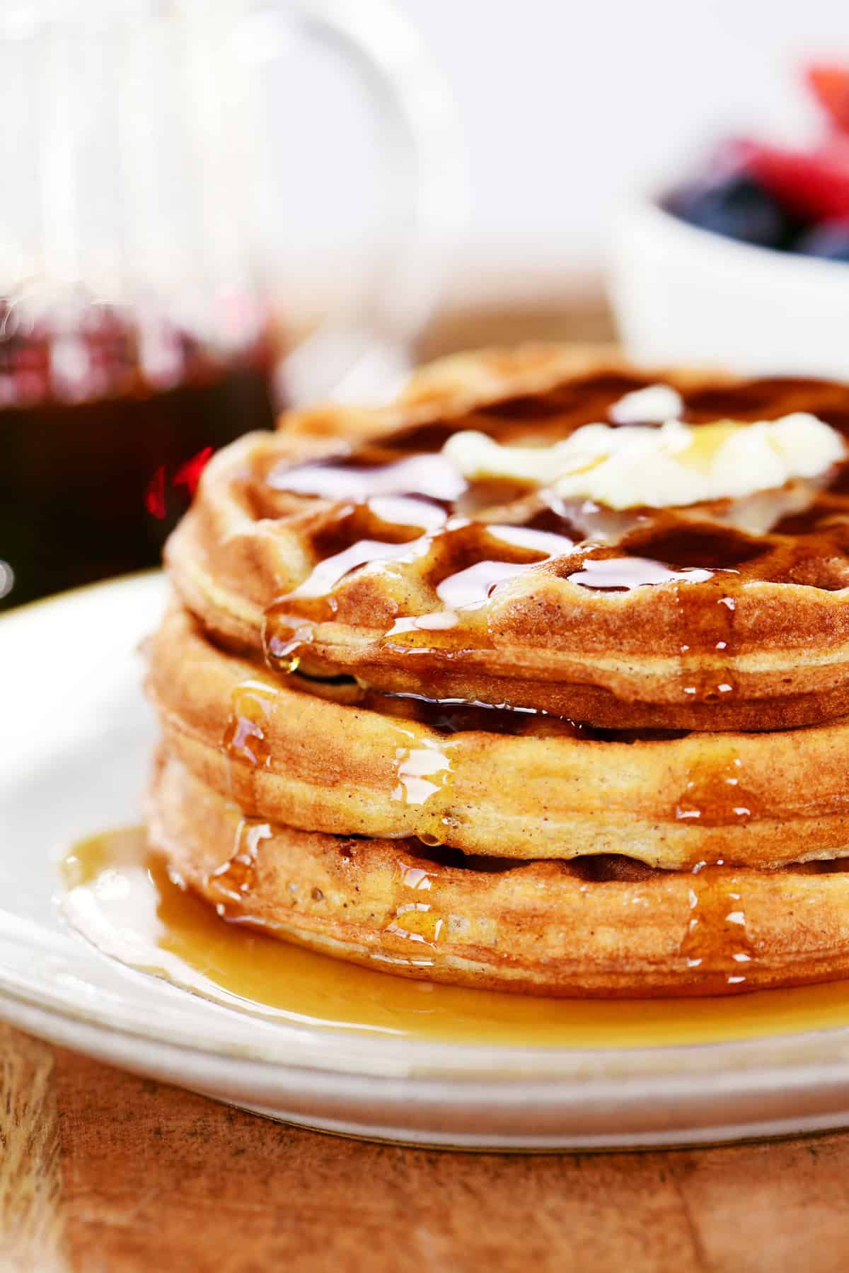 Cottage cheese waffles with butter and syrup on top.