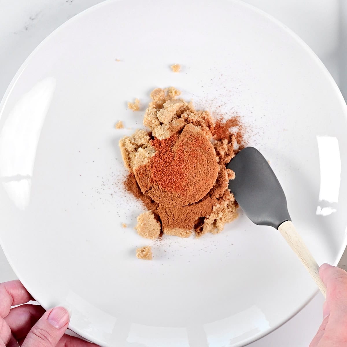 Mixing sugar and spices on a plate.