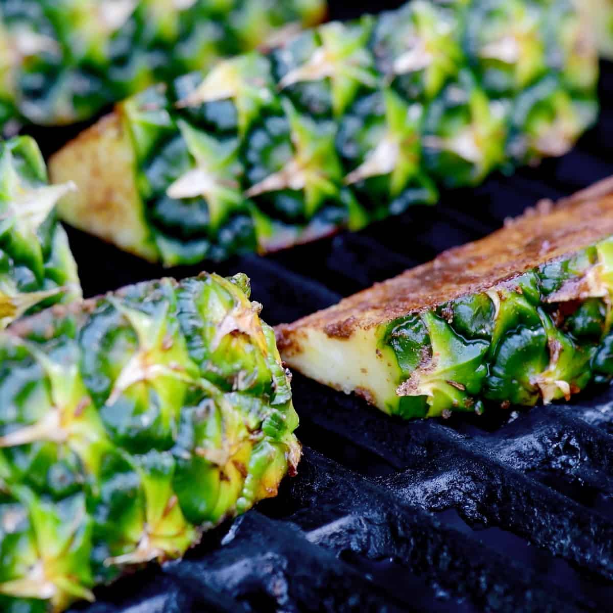 Grilling pieces of pineapple.