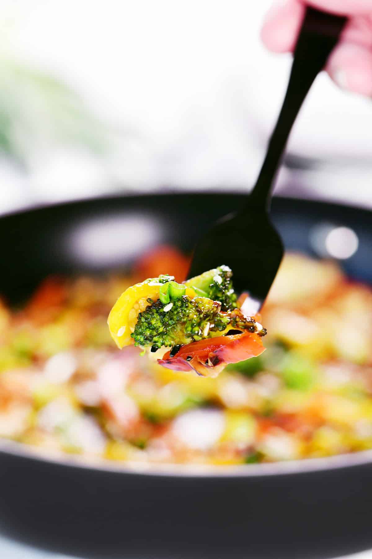 Stir fried vegetables on a black fork.