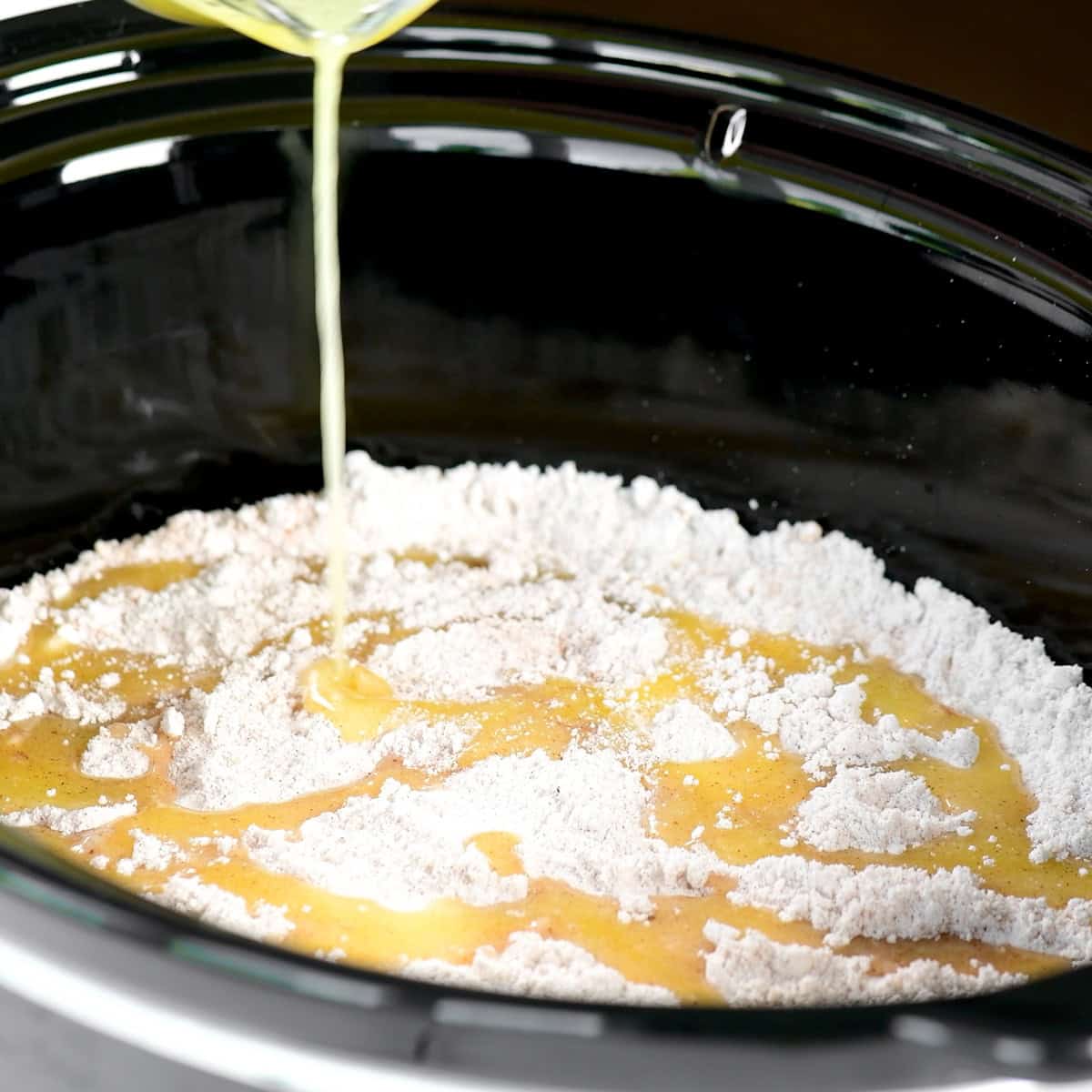 Pouring butter over the top.